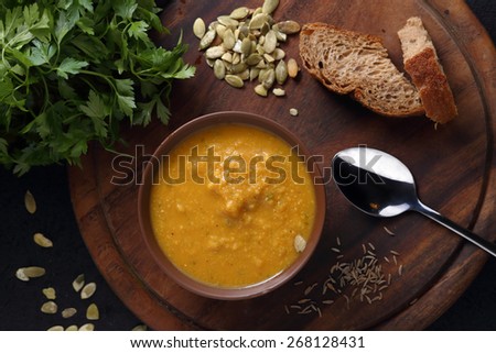 Carrot, lentil and pumpkin soup and bread. Top view