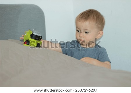 Similar – Image, Stock Photo Serious boy playing on smartphone