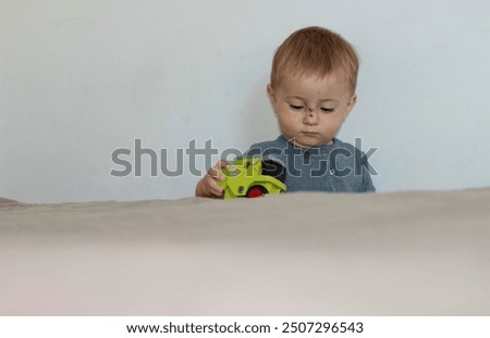 Similar – Image, Stock Photo Serious boy playing on smartphone