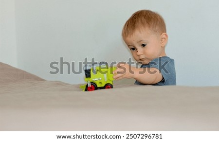 Similar – Image, Stock Photo Serious boy playing on smartphone