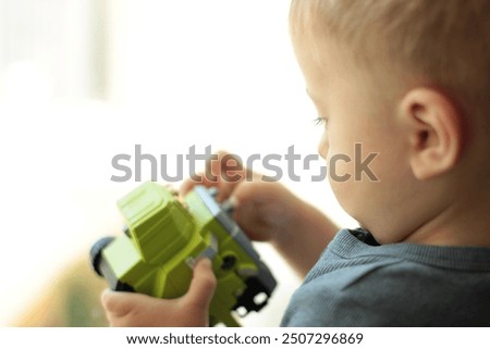 Similar – Image, Stock Photo Serious boy playing on smartphone