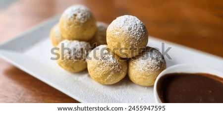 Similar – Image, Stock Photo Mini pancakes with butter and blueberries lie in a plate on a wooden table. Brunch, dessert for children, trending food. Space for text