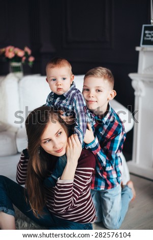 Children hugging mother and happy life, a happy childhood, tender family portrait in warm colors