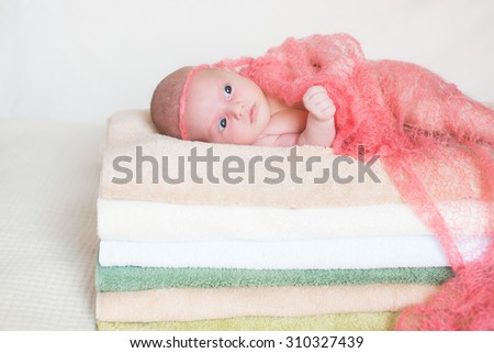 little baby lying on towels. The girl sees sweet dreams. Happy childhood