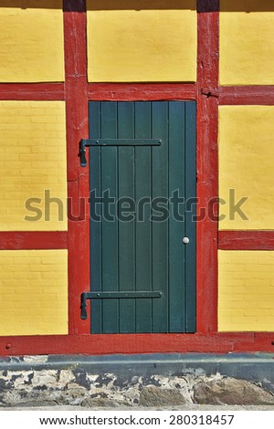 Green door on  yellow wall with red lines