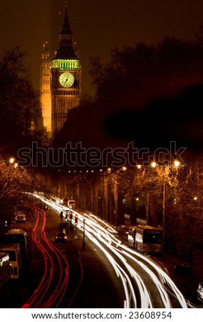 Night time shot of Big Ben in the background and London traffic light streaks in the foreground
