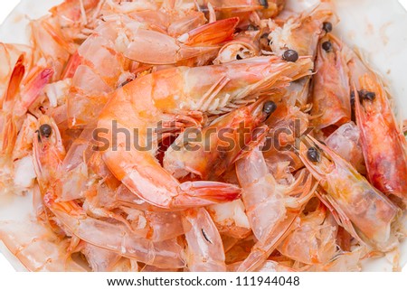 Pile of cooked and peeled shrimp. Detail of the heads and eyes of this seafood. Wastes from cleaning cooked Shrimps.