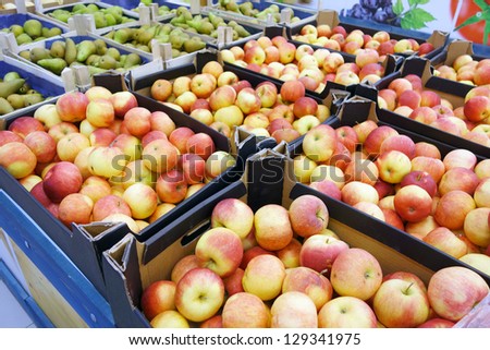 Cardboard boxes with apples and pears in supermarkets