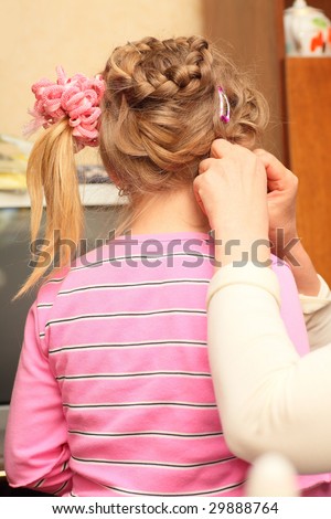 Making Hair for white-headed girl in a pink blouse.