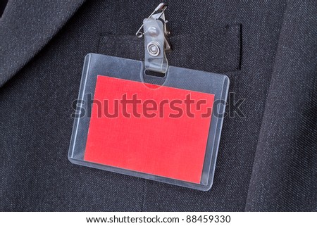 Blank red ID card with copy space on the men\'s suit