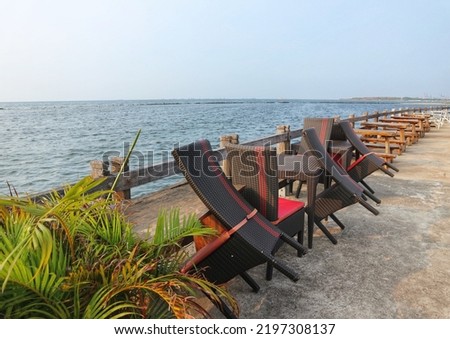 Closed restaurant chairs by the sea since the restaurant is not yet open. ストックフォト © 
