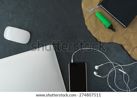 mobile,headset, macbook, notepad on the table