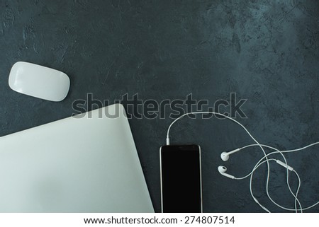 mobile,headset, macbook on the table