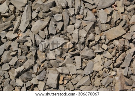 Angular little stones on the ground, stone texture and background.