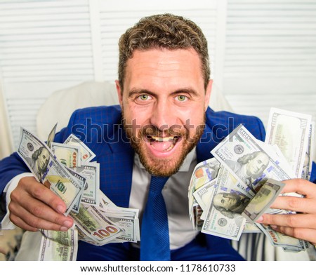 Businessman formal suit hold cash dollars hands. Che k out my profit this month. Earn money easy business tips. Man cheerful happy businessman with pile dollar banknotes. Profit and richness concept. Stock foto © 