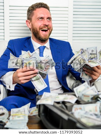 Man cheerful happy businessman with pile dollar banknotes. Profit and richness concept. Businessman formal suit hold cash dollars hands. Che k out my profit this month. Earn money easy business tips. Stock foto © 