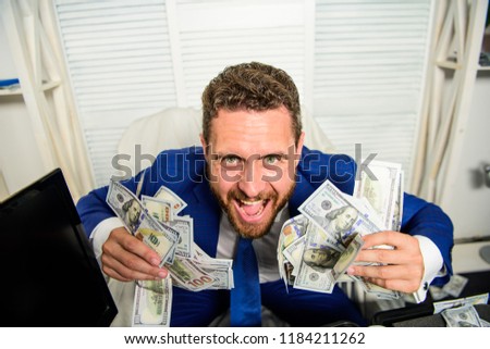 Profit and richness concept. Businessman formal suit hold cash dollars hands. Che k out my profit this month. Earn money easy business tips. Man cheerful happy businessman with pile dollar banknotes. Stock foto © 