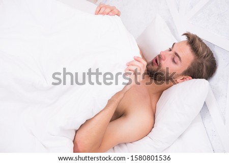 Man looking under blanket. Morning wood formally known nocturnal penile tumescence common occurrence. Male reproductive system. Why men get morning erections. Normal erections occur. Guy relax in bed. Stockfoto © 