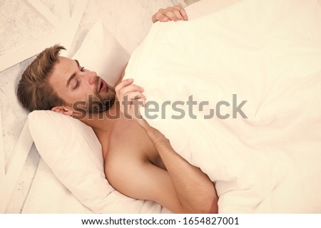 Man looking under blanket. Morning wood formally known nocturnal penile tumescence common occurrence. Male reproductive system. Why men get morning erections. Normal erections occur. Guy relax in bed. Stockfoto © 