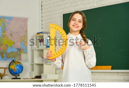 Small child holding ruler for mathematics lesson. Science and Technology. Cute little schoolgirl with geometrical tool for mathematics. Elementary school mathematics or maths. Mathematics matters.