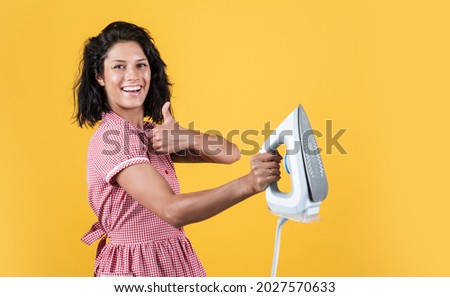 best quality. steaming iron. pinup girl prepare ironing. vintage lady hold modern iron. Everyday life housework. retro woman with iron. happy housekeeper ironing. concept of householding. copy space