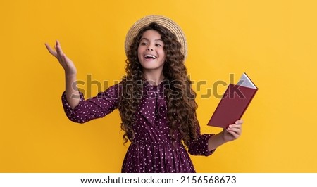 positive child with frizz hair recite book on yellow background Imagine de stoc © 