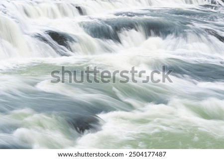 Similar – Image, Stock Photo Waterfall flowing into river in nature