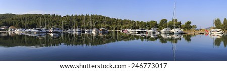 Sithonia, Greece - July 18, 2014: Mirror panorama of yachts and boats. Largest private dock in northern Greece