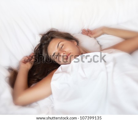 soft image of an attractive young woman sleeping in her bed