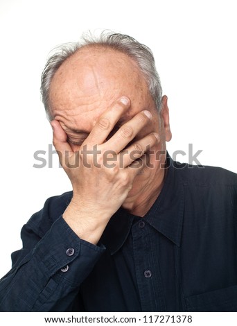 Pain. Elderly man covers his face with hand