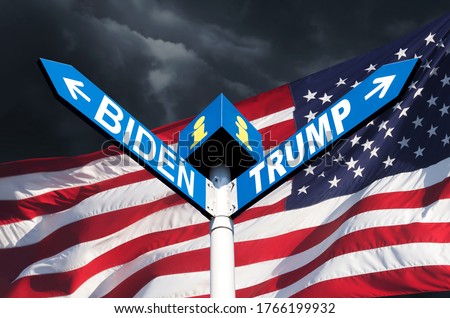 US presidential race. The names of Presidents Donald Trump and Joe Biden on the roadside sign on the background of the American flag and a stormy sky