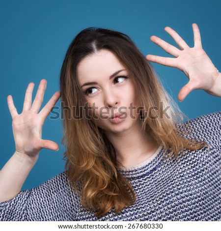 Portrait of emotional girl gesturing with facial expression of surprise