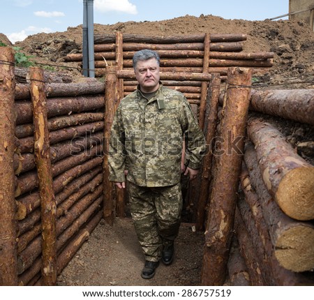 DONETSK REG, UKRAINE - Jun 11, 2015: President of Ukraine, Supreme Commander of Armed Forces of Ukraine Petro Poroshenko examines the construction of fortifications in the Donetsk region
