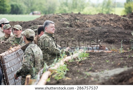 DONETSK REG, UKRAINE - Jun 11, 2015: President of Ukraine, Supreme Commander of Armed Forces of Ukraine Petro Poroshenko examines the construction of fortifications in the Donetsk region
