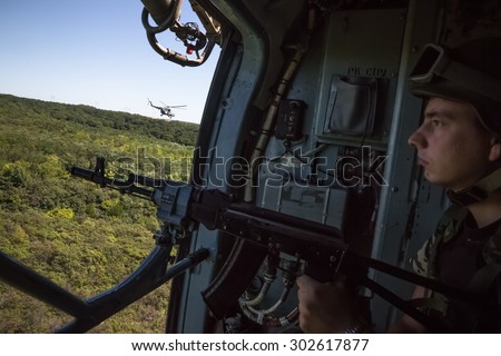 DONETSK REG, UKRAINE - Aug 02, 2015: Ukrainian army helicopter patrols the area of the antiterrorist operation in the Donetsk region