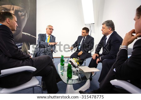 KIEV, UKRAINE - Sep 11, 2015: President of Ukraine Petro Poroshenko, former Polish Foreign Minister Radoslaw Sikorski and former Swedish Foreign Minister Carl Bildt during a meeting in Kiev