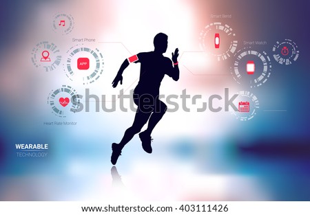 Wearable technology fitness tracker, smart phone, heart rate monitor and smart watch with man running silhouette in blur background