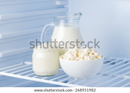tasty and healthy dairy products in the refrigerator: sour cream, cottage cheese and milk