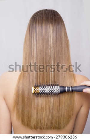 Blonde hair being brushed
