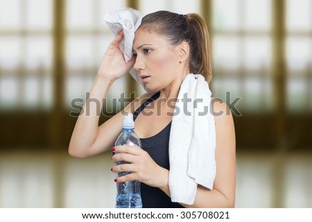 Woman sweating with a bottle of water