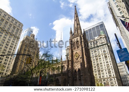 NEW YORK CITY, NEW YORK - MAY 01, 2014: Trinity Church in Manhattan, NYC which was build in 1846. Under construction One World Trade Center building is visible in the background.