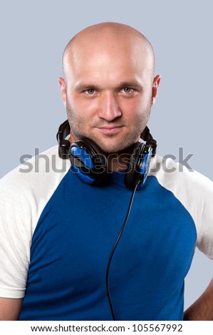 man with earphones on gray background