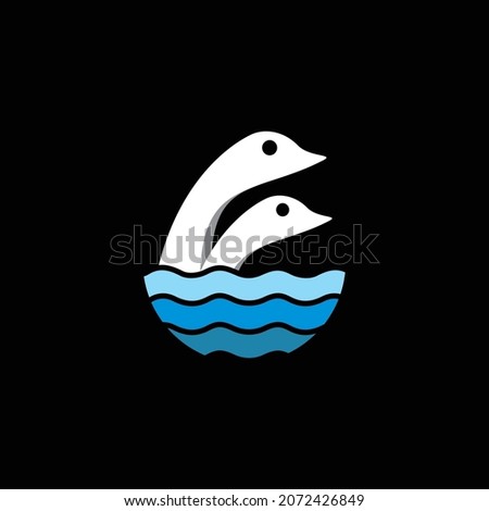 two swans swimming freely in the blue sea