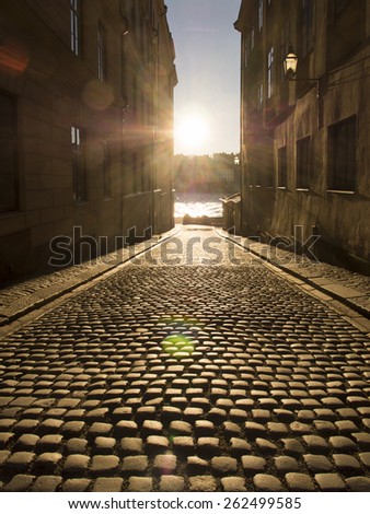 Pavement of nicely baked breads. A sunny winter day in Stockholm Old Town. The mid-day sun cast beautiful golden light onto a sloped road, where the stones appeared freshly out of a bakery.