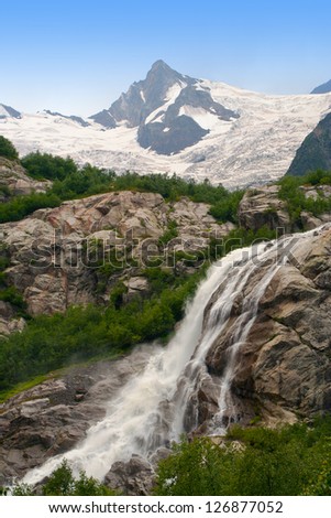 Waterfall flowing from Alibeksky glacier, Western Caucasus, Russia