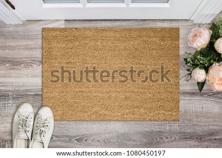 Blank coir doormat before the door in the hall. Mat on wooden floor, flowers and shoes. Welcome home, product Mockup ストックフォト © 