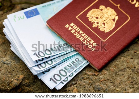 In the russian passport lies a pack of euros lying on the street. Inscription in Russian passport of the Russian Federation