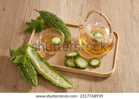 On the bamboo tray featured a transparent tea set with bitter melon. Bitter melon (Momordica charantia) tea has a lot of vitamin C and anti-aging substances Stok fotoğraf © 