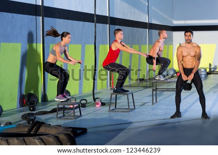 Fitness box jump people group and kettlebell man at gym