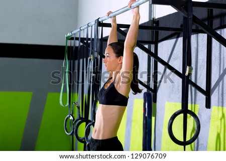 Fitness toes to bar woman pull-ups 2 bars workout exercise at gym